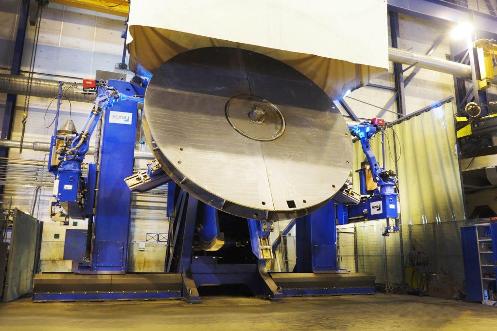 robots welding a big piece of equipment