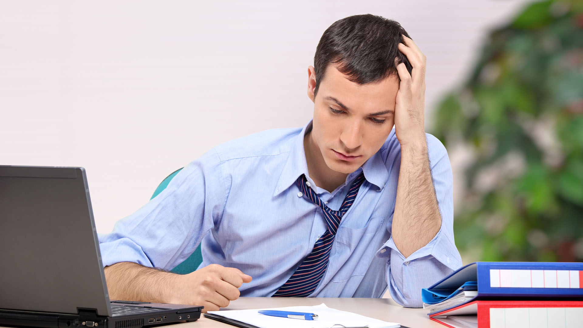 a businessman at a table looking desperate