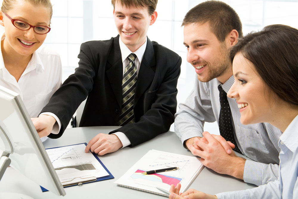 A a planning team gathered around a screen